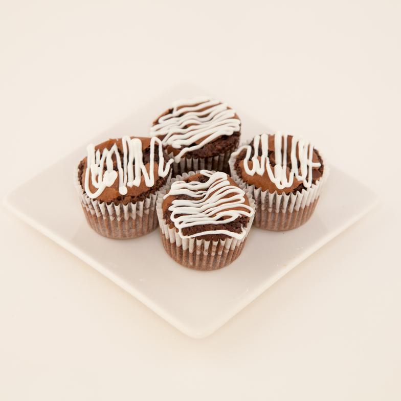 Individual triple chocolate brownies (tarlet size) drizzled with white chocolate 